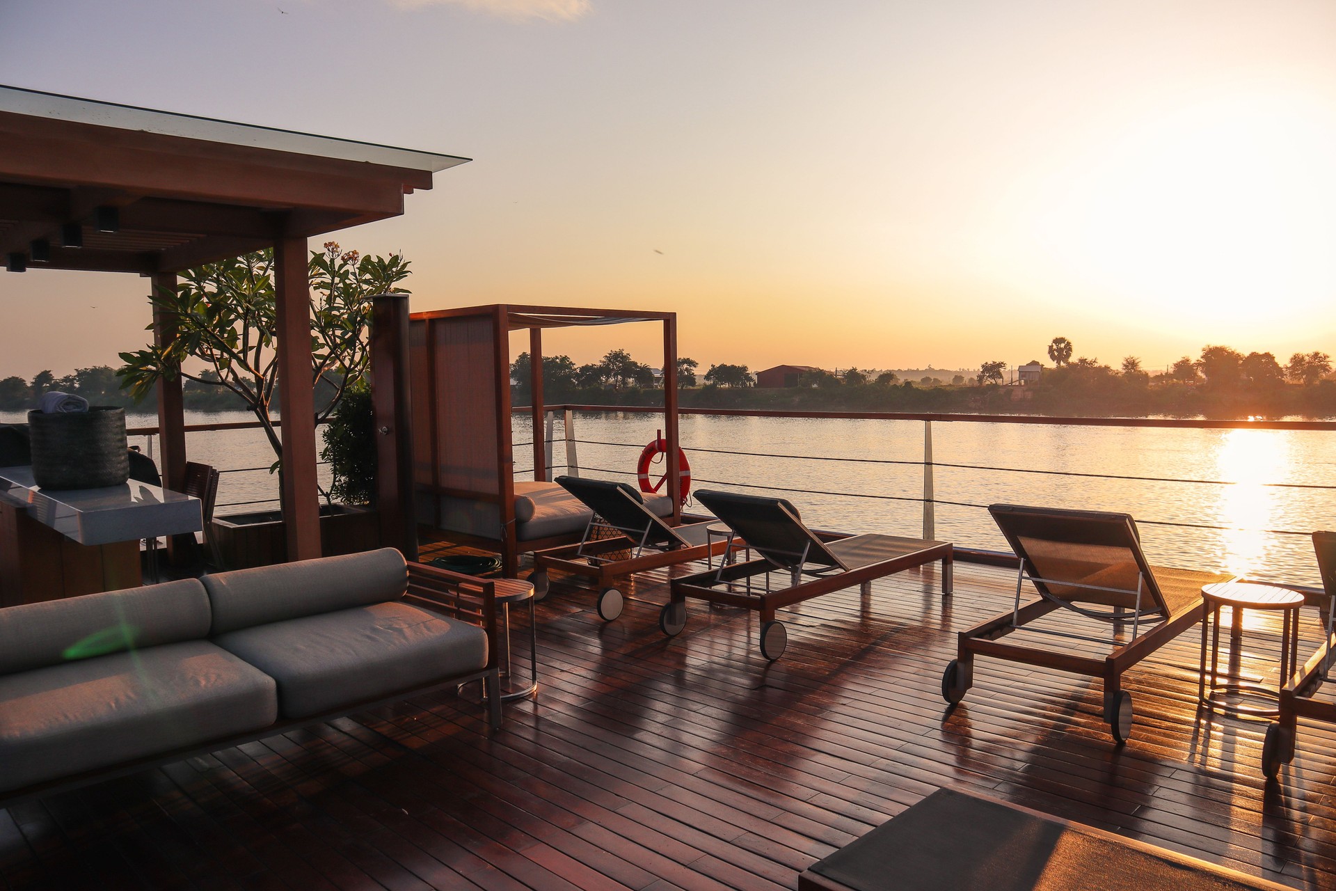 Sunset over the deck of a Mekong River cruise ship—capturing the serenity and cultural richness of personalized cruise experiences with Curated Passports.